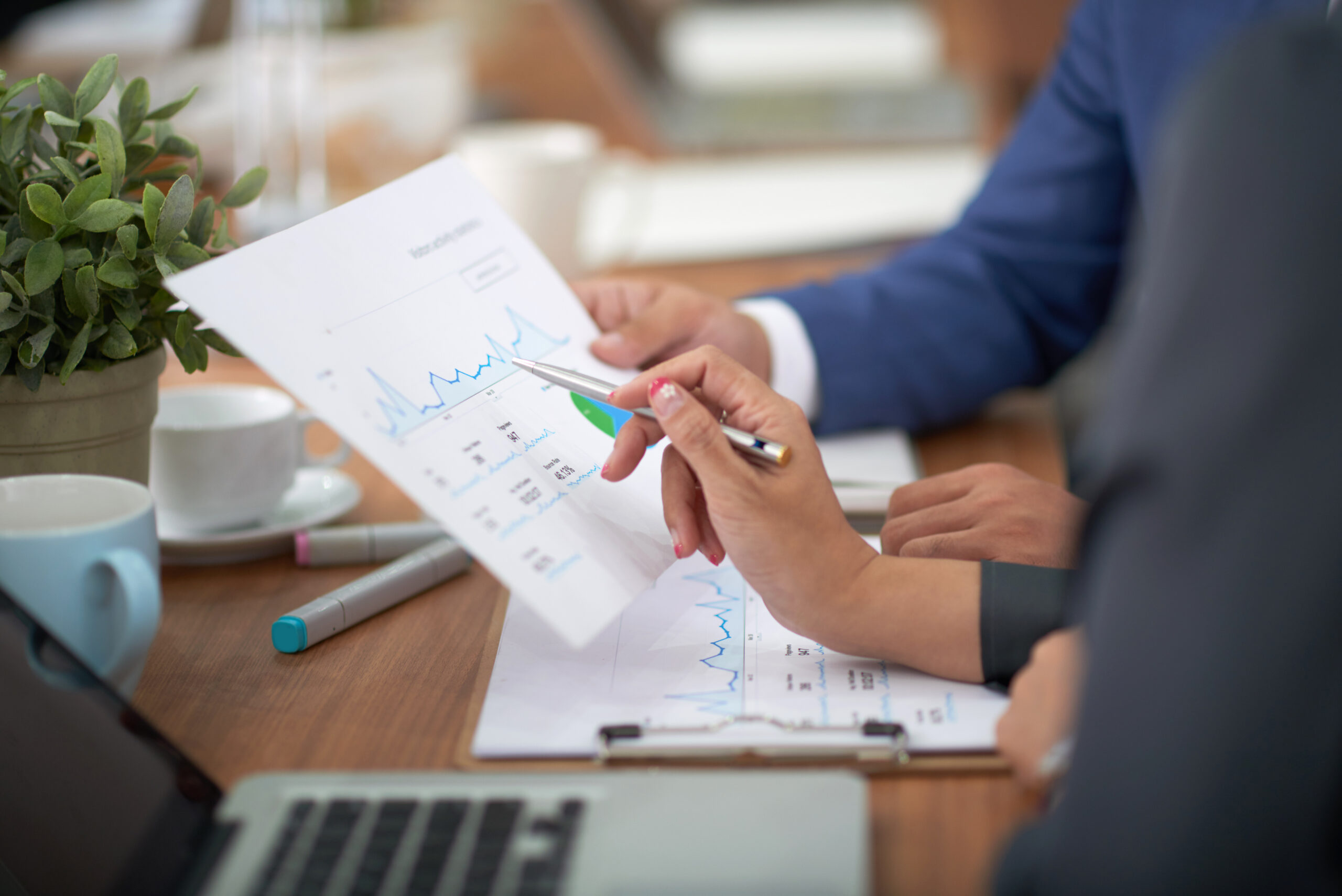 https://www.grupodemejoracontinua.com/wp-content/uploads/2026/04/hands-man-woman-business-attire-sitting-desk-office-discussing-graph-scaled.jpg